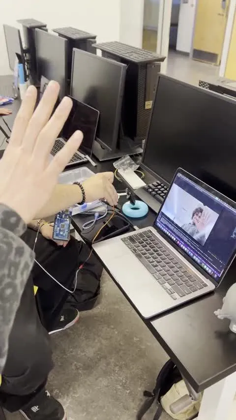 Hand held in front of the laptop camera with tracking running